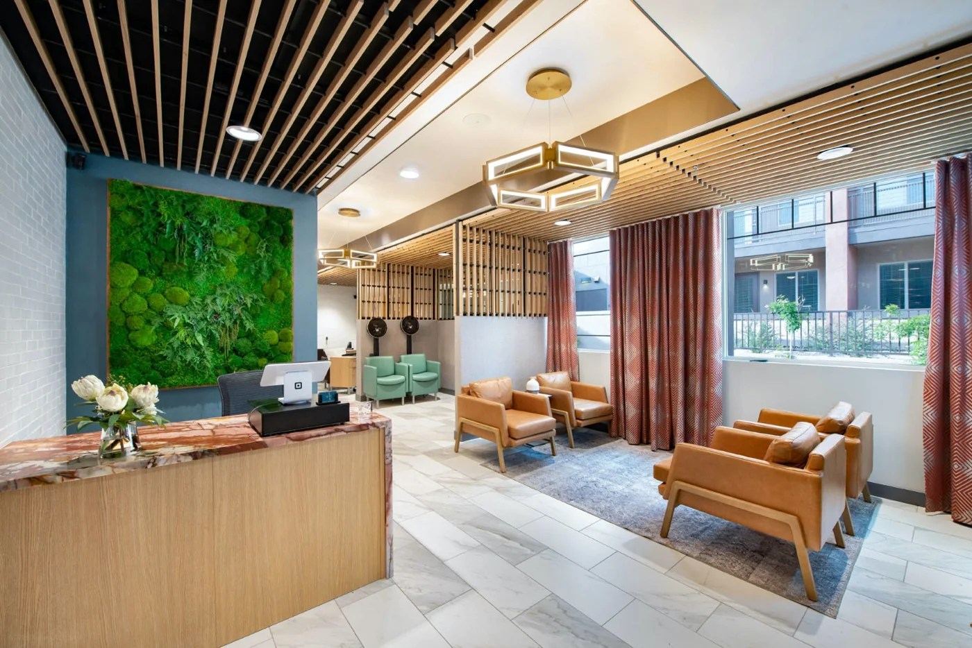A welcoming senior community salon with warm wood finishes, comfortable seating and a reception counter.